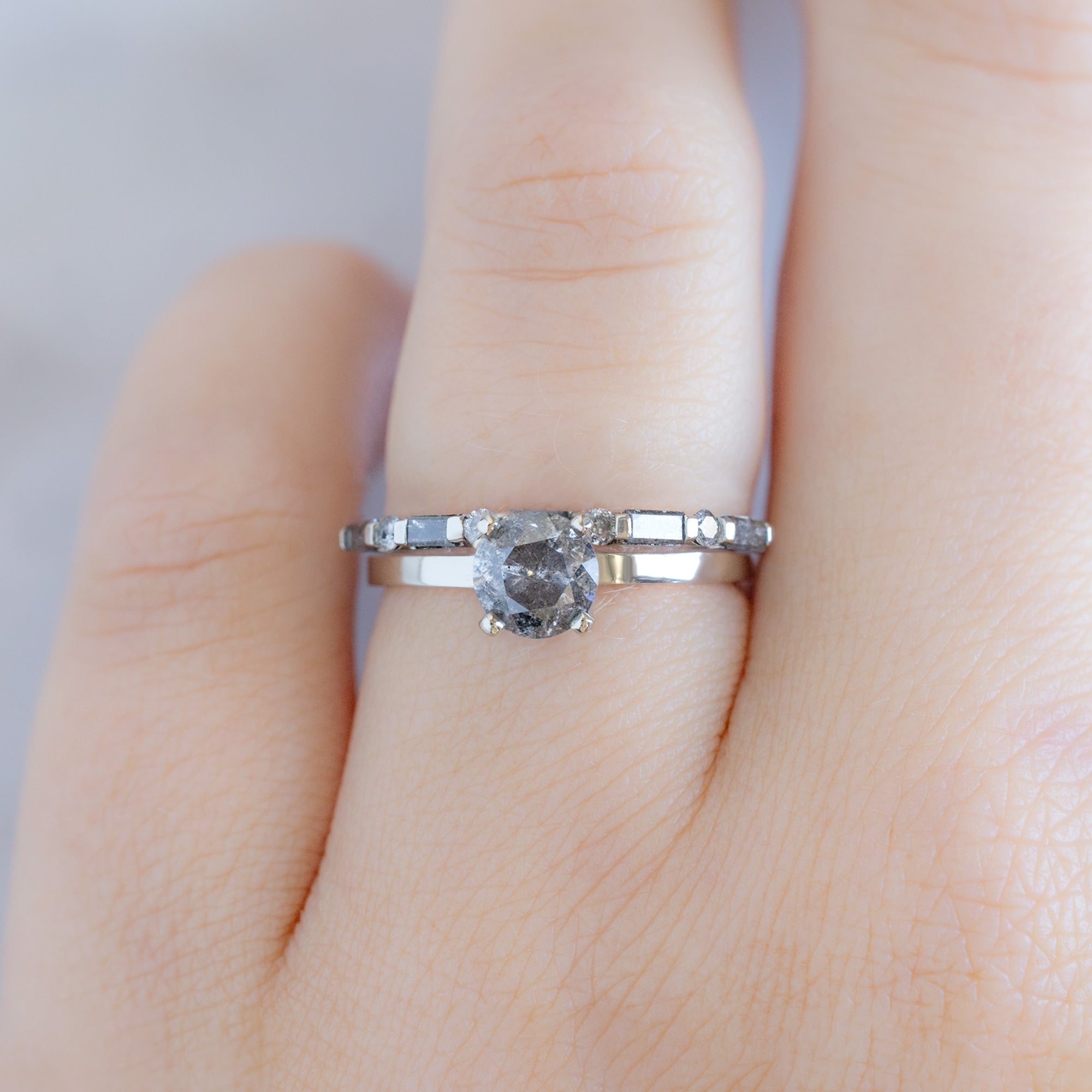 The Luxe Baguette Salt and Pepper Diamond Eternity Band in 14K White Gold stacked with round salt and pepper diamond engagement ring on model