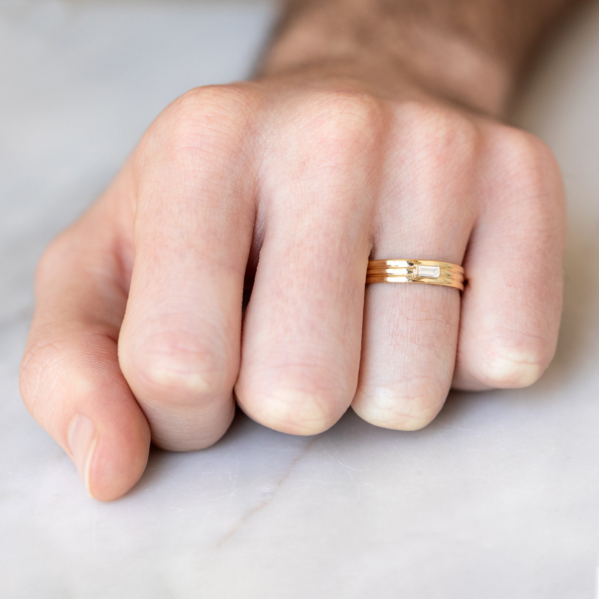 The Men's Stratum Band with a Lab Grown Baguette in 18K Yellow Gold on Model