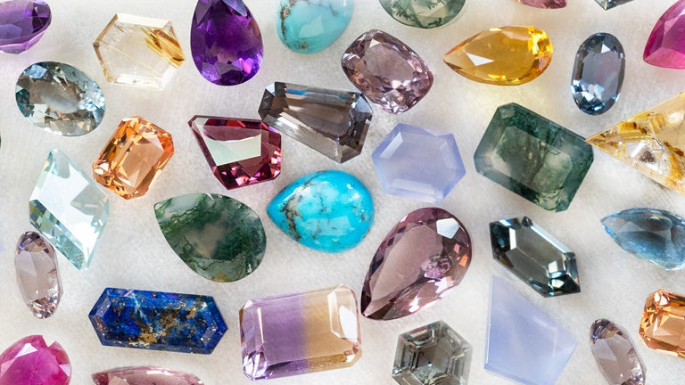 loose assorted gemstones on white background