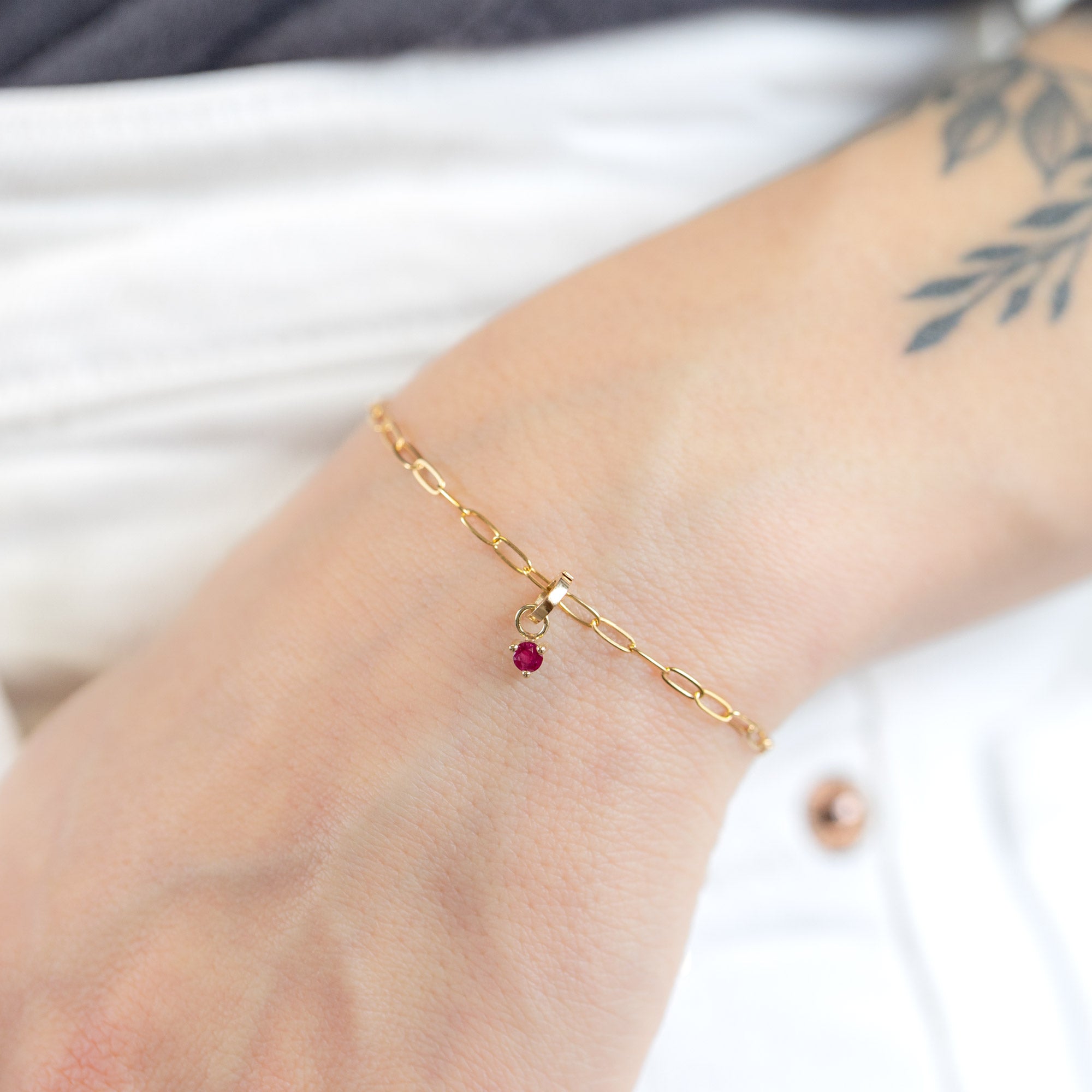 buy:the-ruby-birthstone-charm-10k-yellow-gold,the-drawn-cable-chain-charm-bracelet-10k-yellow-gold