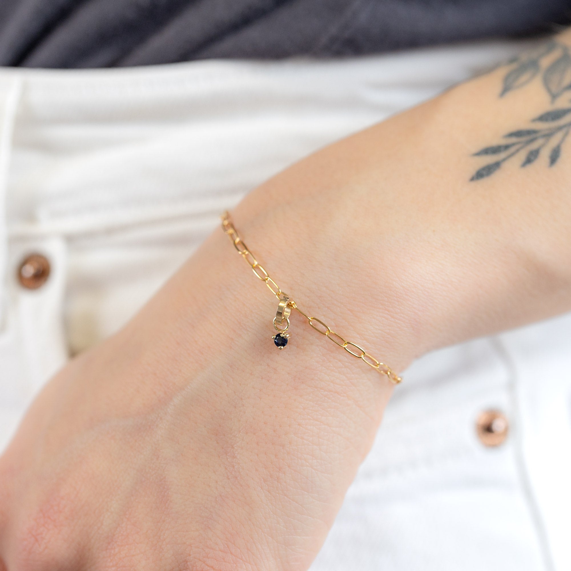 The Sapphire Birthstone Charm in 10K Yellow Gold on Drawn Cable Chain Bracelet on Model