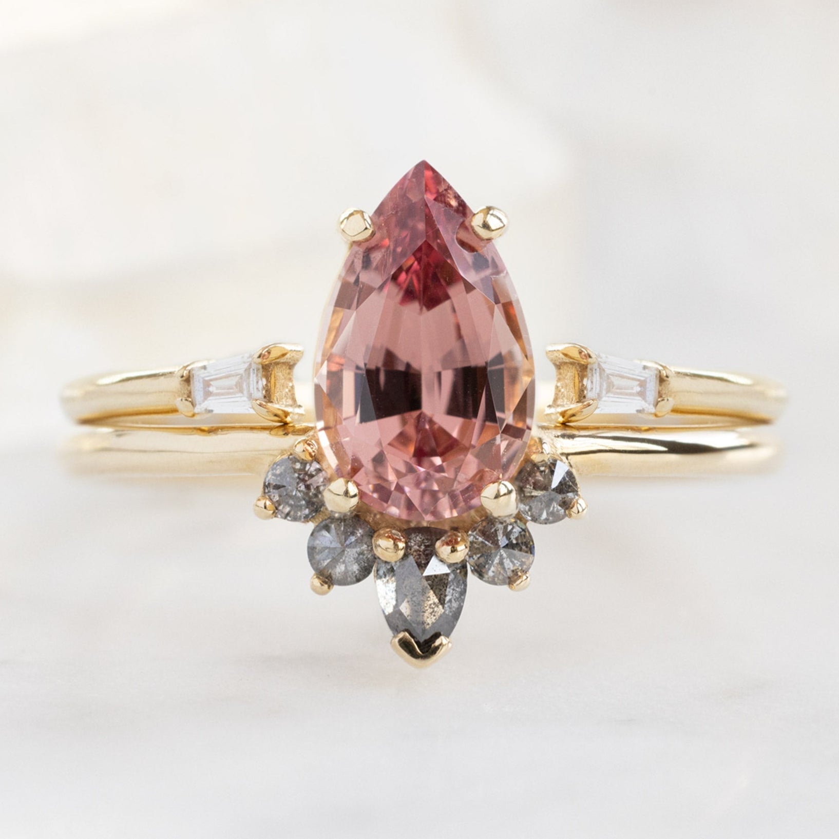 The Aster Ring with a 1.59ct Pear Garnet in 14K Yellow Gold Stacked with the Open Cuff White Diamond Baguette Stacking Band