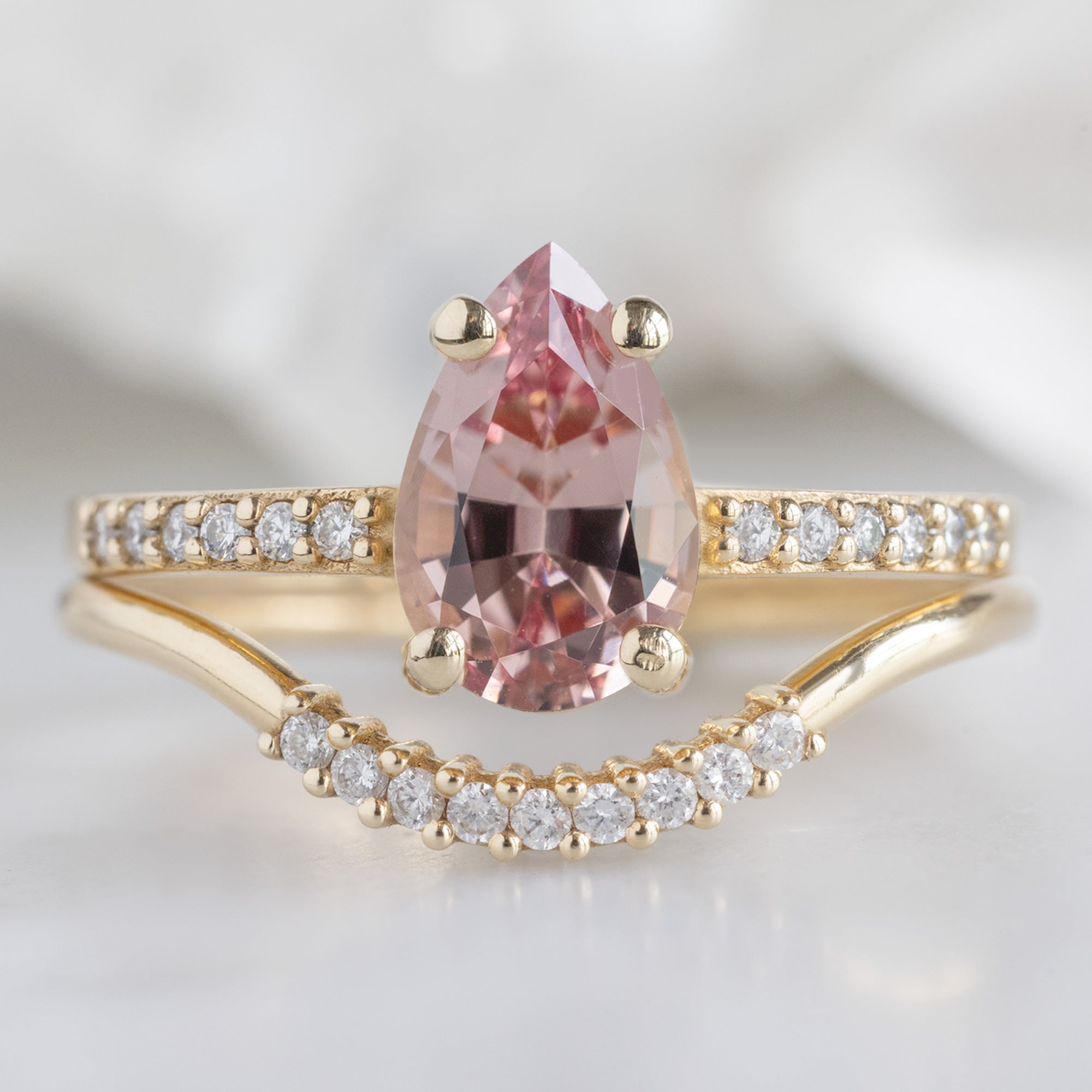 The Willow Ring with a 1.00ct Pear Garnet in 14K Yellow Gold Stacked with the White Diamond Pavé Arc Stacking Band