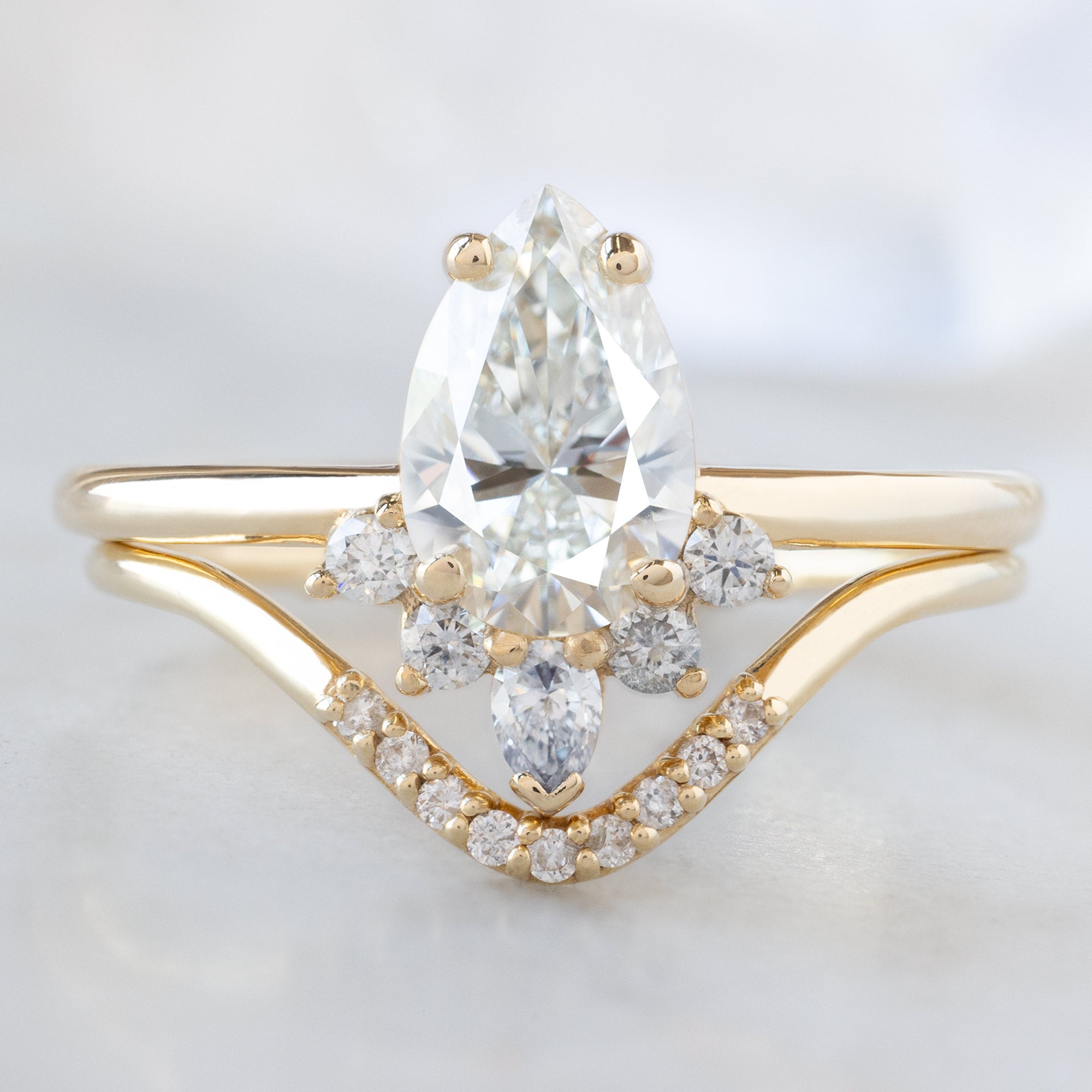 The Aster Ring with a 0.80ct Pear Natural White Diamond in 14K Yellow Gold Stacked with the White Diamond Pavé Peak Stacking Band