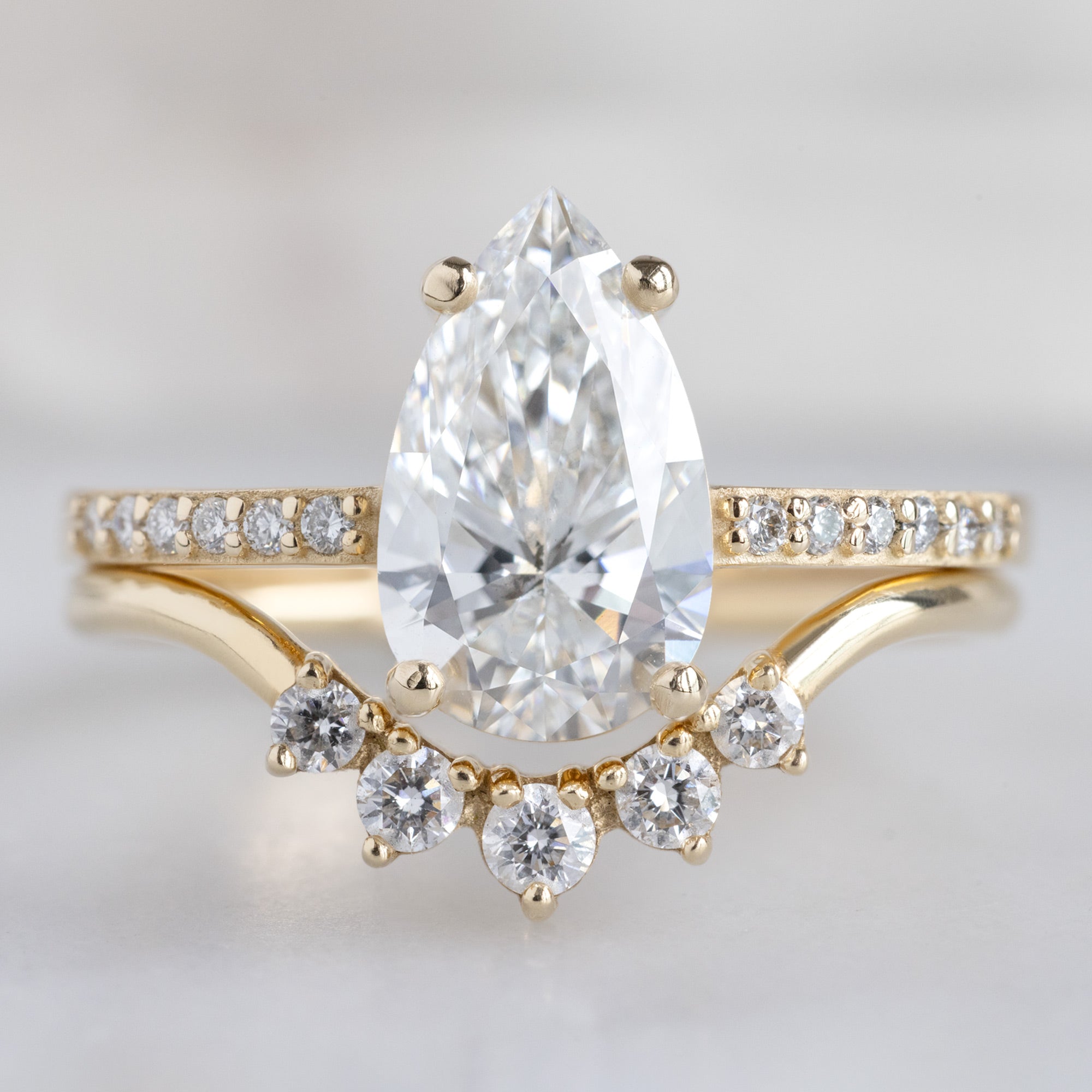 The Willow Ring with a Lab Grown Pear White Diamond in 14K Yellow Gold Stacked with the Round White Diamond Sunburst Stacking Band