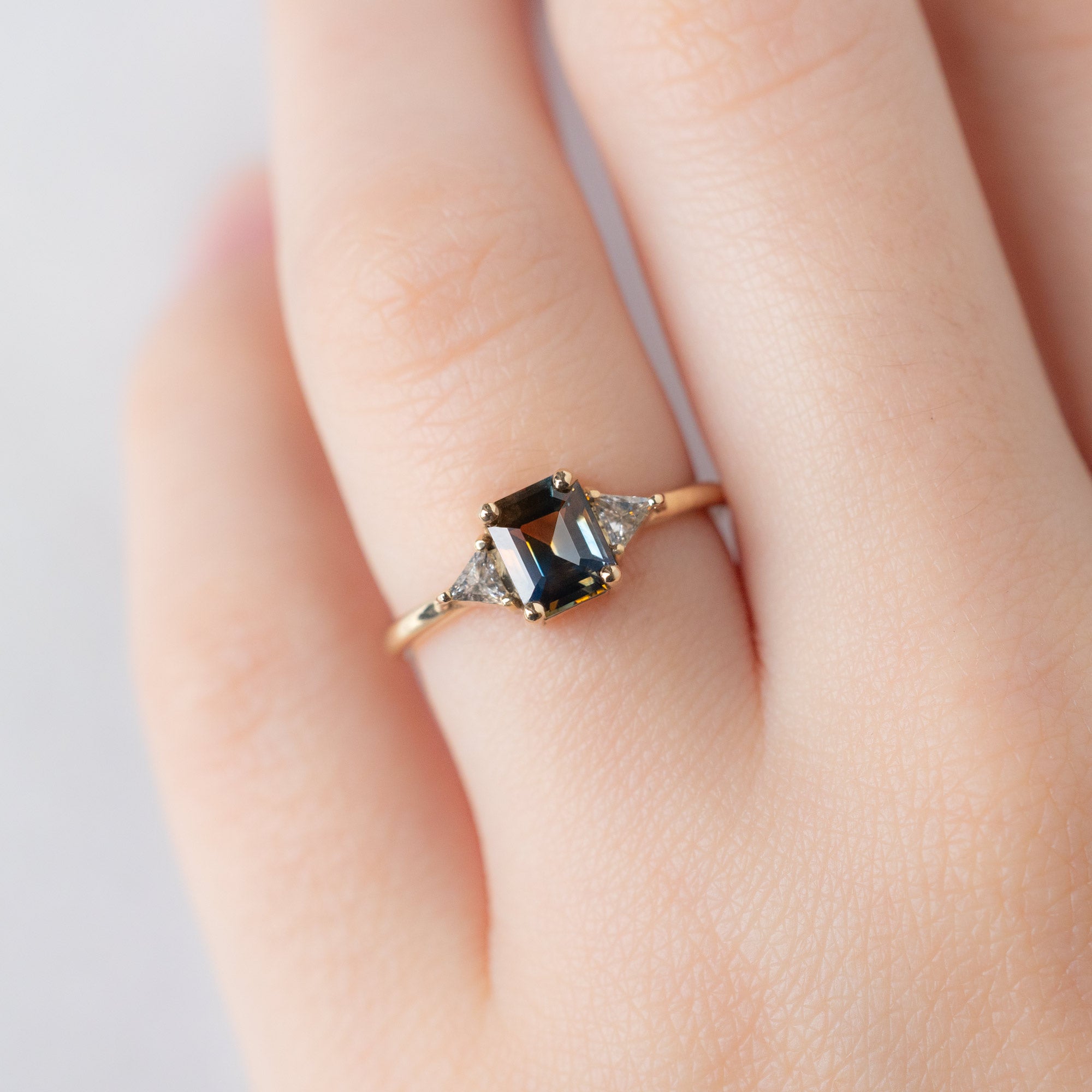 The Jade Ring with a 1.19ct Emerald Cut Parti Sapphire in 14K Yellow Gold on Model