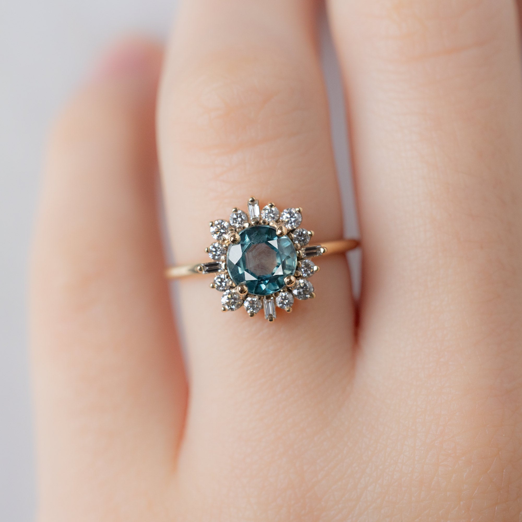 The Compass Ring with a 1.66ct Round Blue Sapphire in 14K Yellow Gold on Model