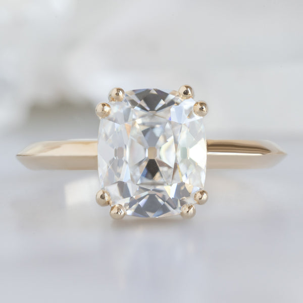 The Bryn Ring with a 2.04ct Old Mine Cut Lab Grown White Diamond in 14K Yellow Gold on White Marble Surface