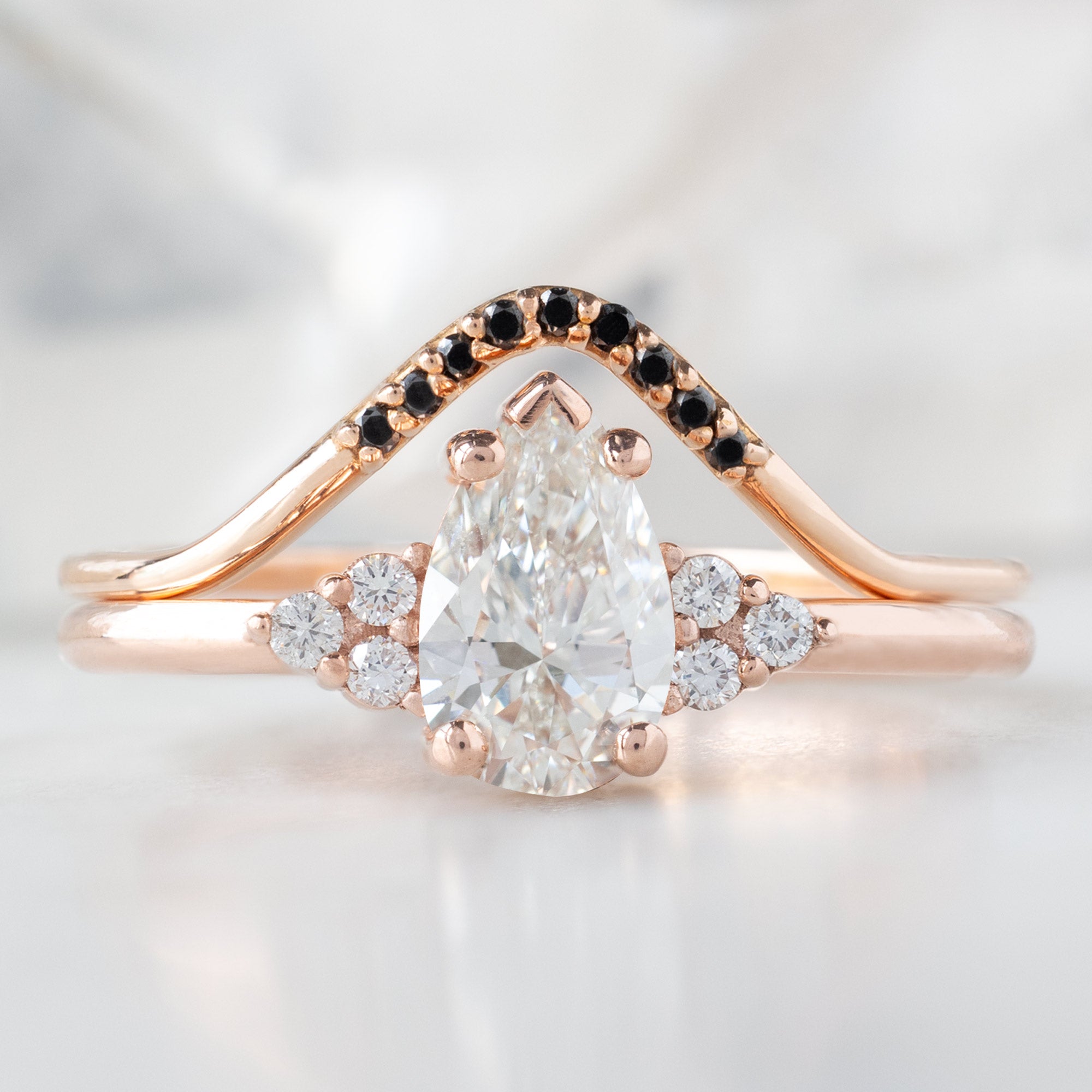 The Ivy Ring with a 0.65ct Pear White Diamond in 14K Rose Gold Stacked with the Black Diamond Pavé Peak Stacking Band