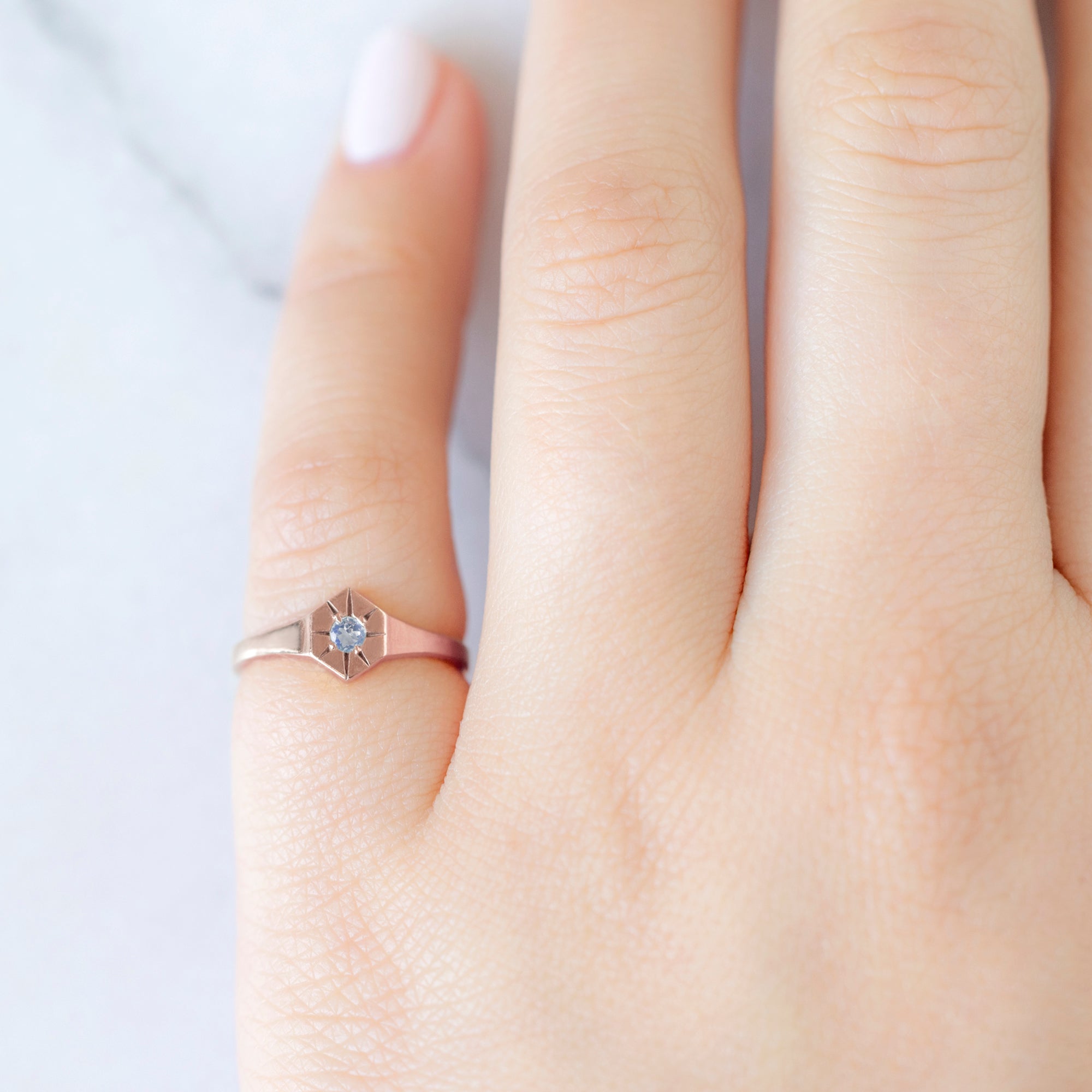 Custom Moonstone Birthstone Signet Ring | 10K Rose Gold. Displayed on model's left hand pinky finger. 