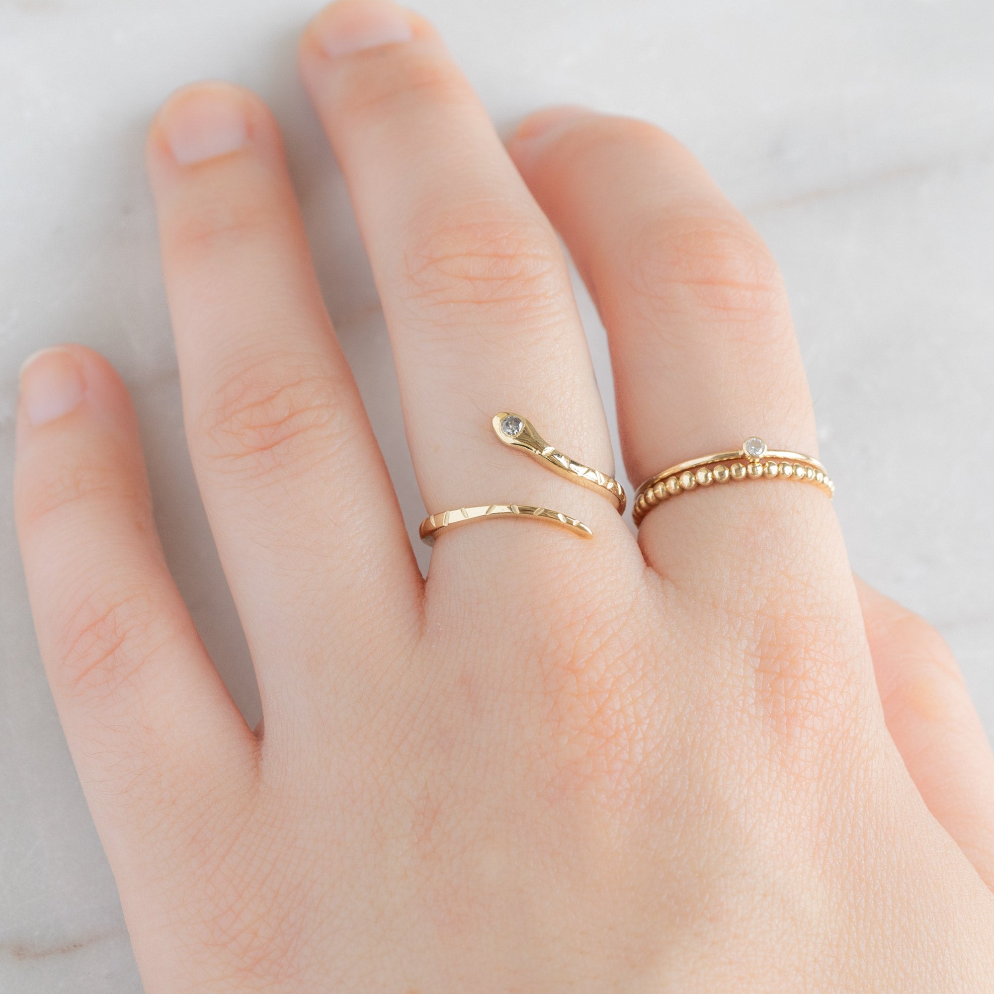 buy:the-salt-and-pepper-diamond-serpent-ring-14k-yellow-gold,the-teensy-custom-white-diamond-stacking-ring-14k-yellow-gold,the-gold-beaded-stacking-ring-14k-yellow-gold
