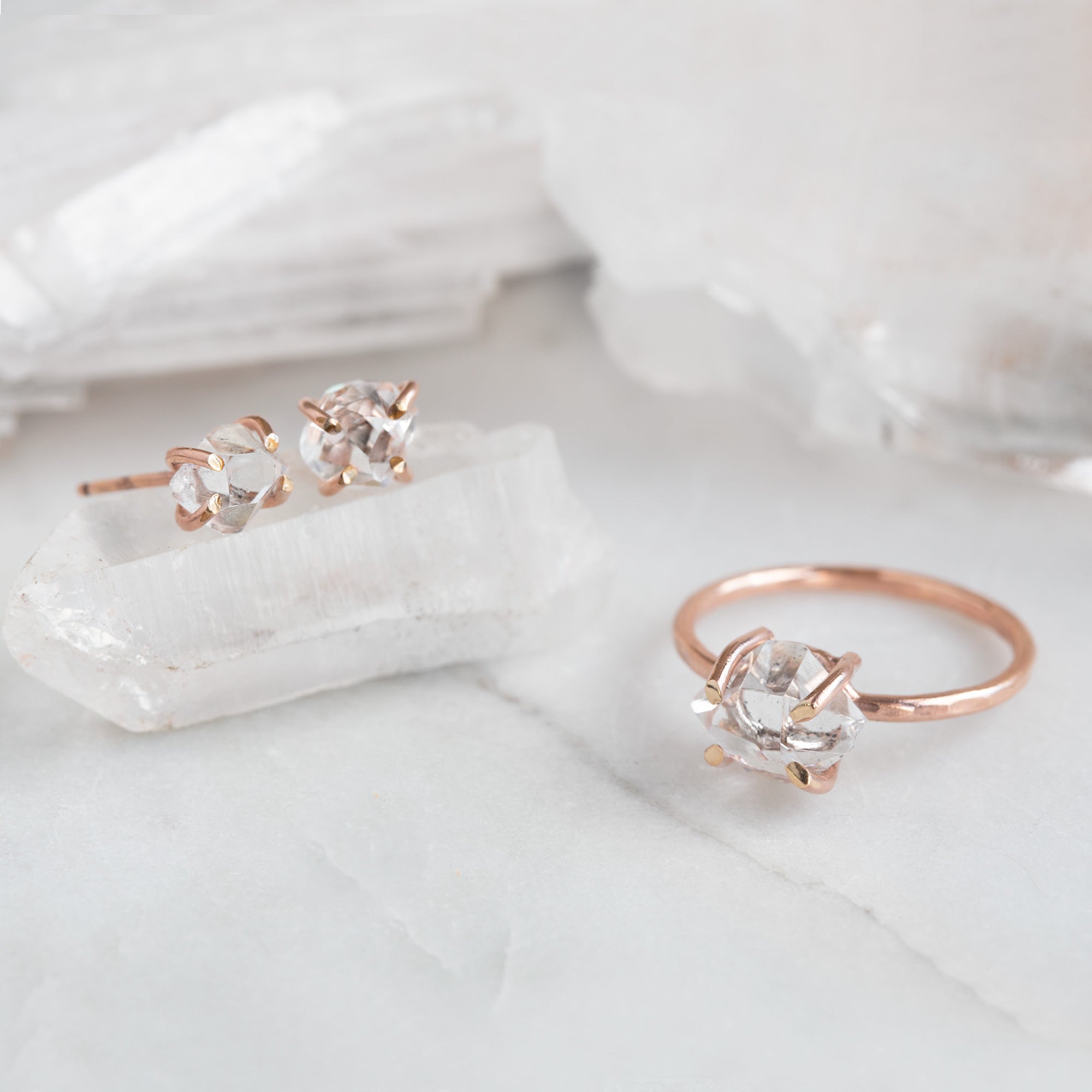 The Herkimer Diamond Ring | Rose Gold Filled. Displayed on marble surface alongside matching earrings. 