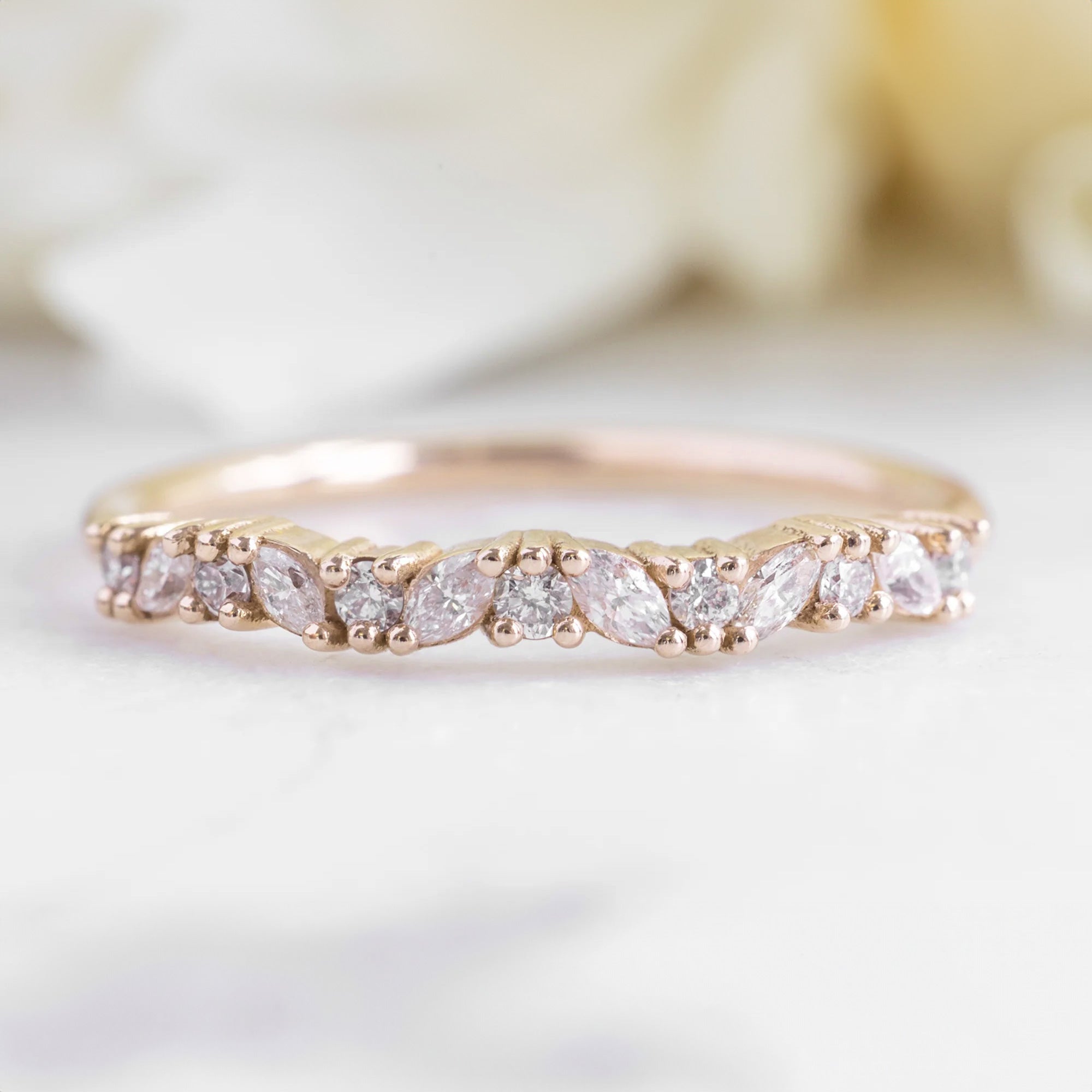 The Marquise Confetti Wedding Band in 14K Yellow Gold on White Marble Tile