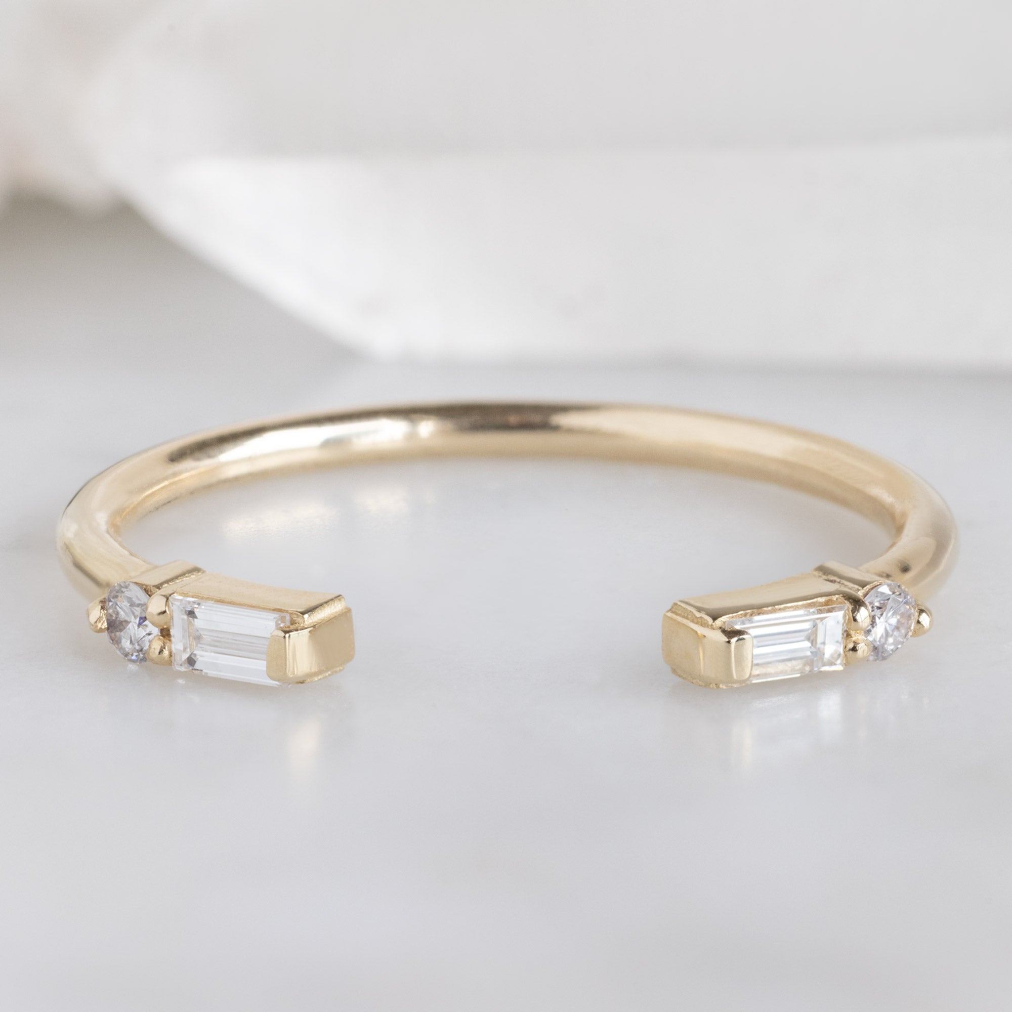 The Luxe Open Cuff White Baguette Diamond Stacking Band in 14K Yellow Gold on White Marble