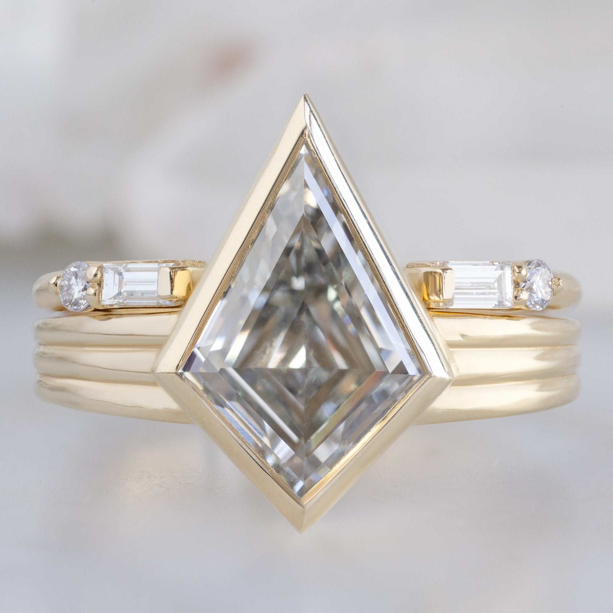 The Luxe Open Cuff White Baguette Diamond Stacking Band in 14K Yellow Gold stacked with white diamond engagement ring